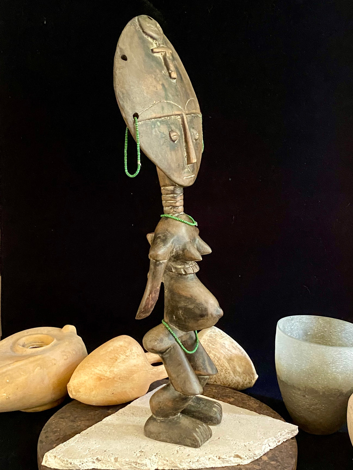 Akuaba or Aquaba Doll, Asante, from Ghana. Mid 20th Century, vintage fertility idol with carved neck rings and beaded decoration and carries a smaller, more traditional akuaba figure on her forehead. She is detailed on the back, wearing a carved baby carrier. Height 45.5 cm