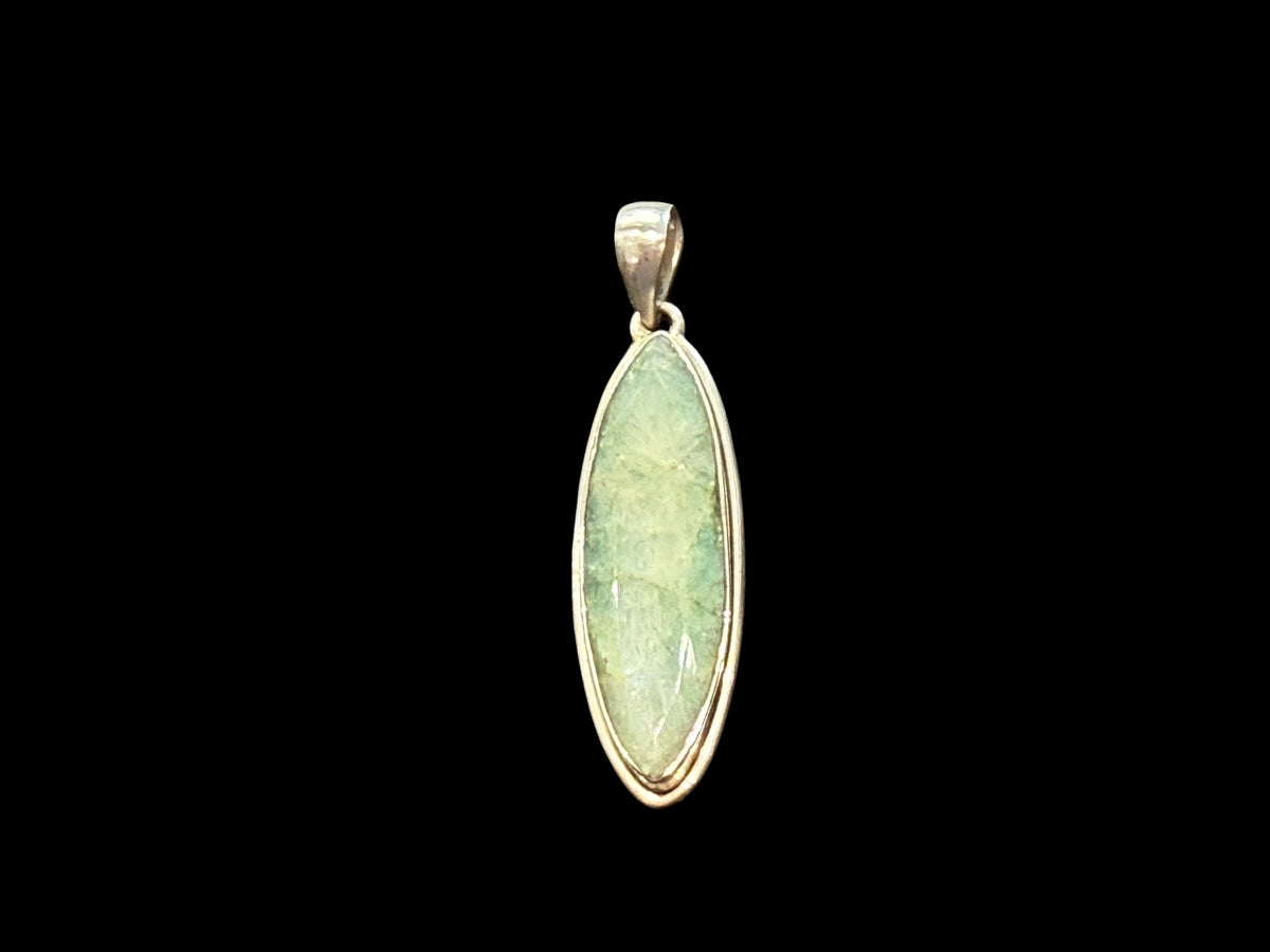 Long emerald pendant, frosted light green colour, facet cut, set in a shadow box mounting of sterling silver. Large bail. Height 6 cm, width 1.7 cm.