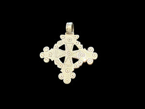 Mid 20th century round Ethiopian silver crucifix, cut from a Marie Therese silver thaler. Almost identical markings on both sides. Small amount of wear at the head of the bail. Height including bail 5.1 cm