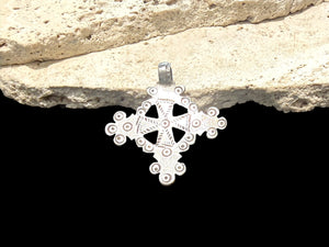 Mid 20th century round Ethiopian silver crucifix, cut from a Marie Therese silver thaler. Almost identical markings on both sides. Small amount of wear at the head of the bail. Height including bail 5.1 cm