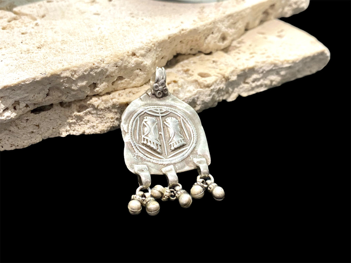 Antique silver amulet depicting the feet of the goddess Lakshmi. High grade silver, mid to late 19th century. India. Worn to attract wealth and good fortune. Height 5.5 cm