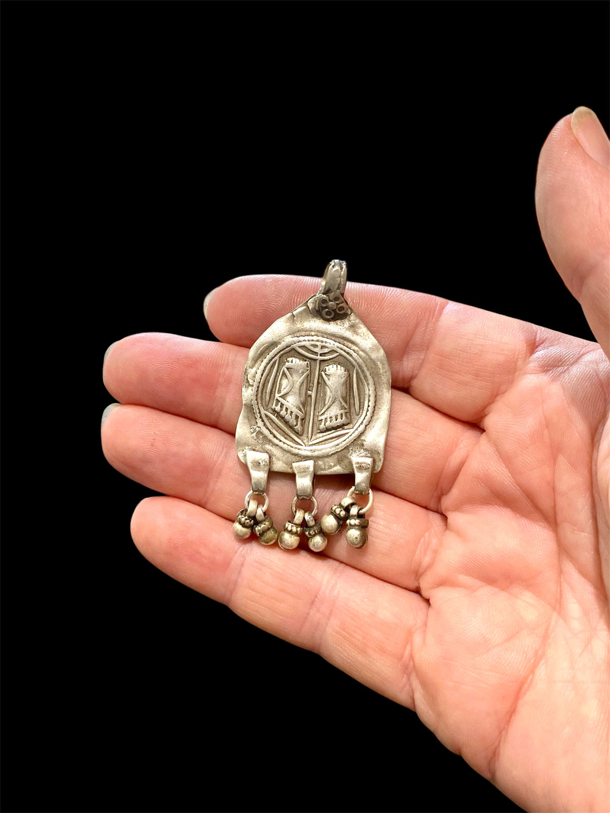 Antique silver amulet depicting the feet of the goddess Lakshmi. High grade silver, mid to late 19th century. India. Worn to attract wealth and good fortune. Height 5.5 cm