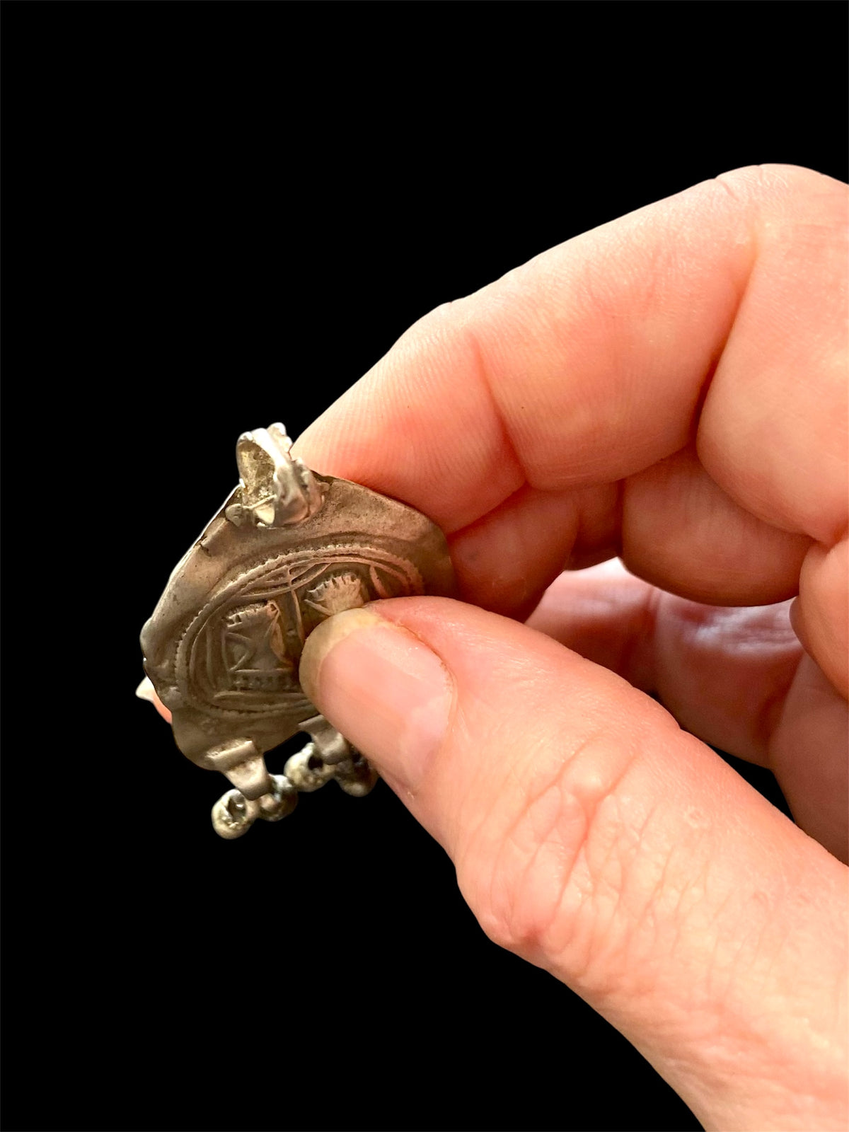 Antique silver amulet depicting the feet of the goddess Lakshmi. High grade silver, mid to late 19th century. India. Worn to attract wealth and good fortune. Height 5.5 cm