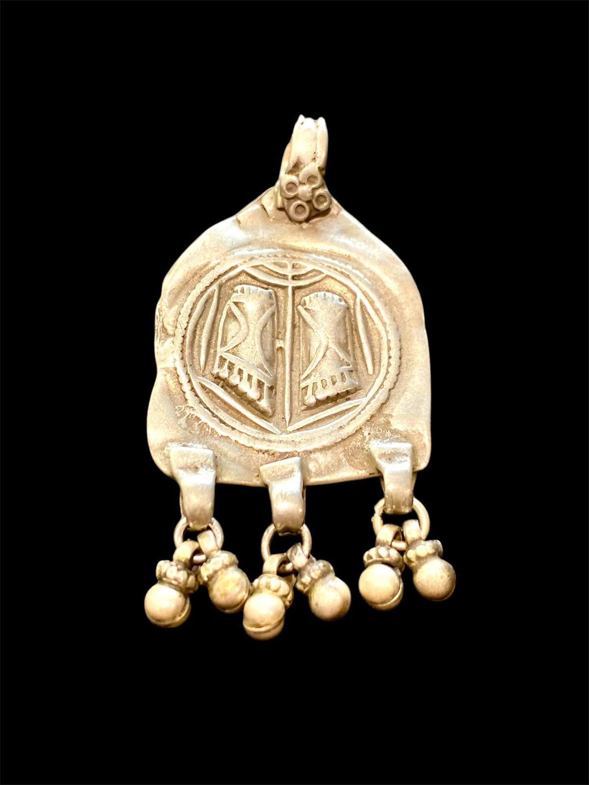 Antique silver amulet depicting the feet of the goddess Lakshmi. High grade silver, mid to late 19th century. India. Worn to attract wealth and good fortune. Height 5.5 cm