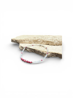Fine beaded bracelet of facet cut ruby and round rainbow moonstone beads, finished with sterling silver beads and clasp. Length 20.6 cm, size 19 cm