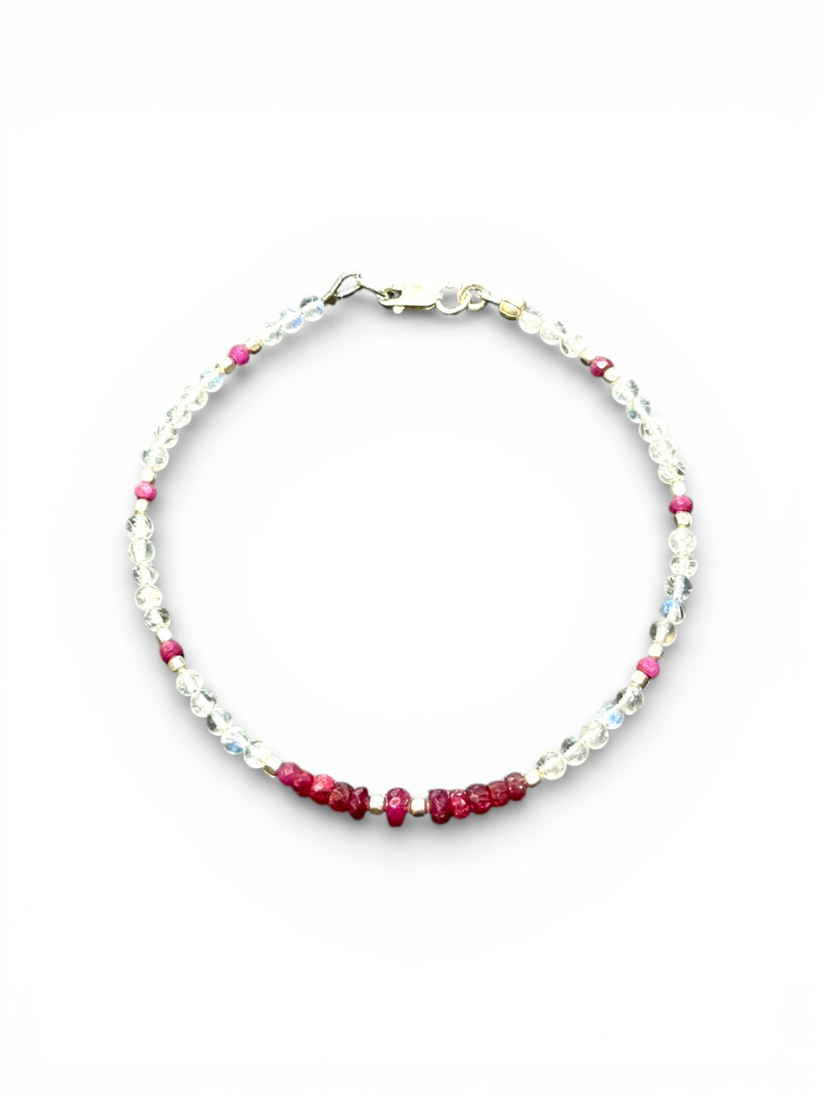 Fine beaded bracelet of facet cut ruby and round rainbow moonstone beads, finished with sterling silver beads and clasp. Length 20.6 cm, size 19 cm