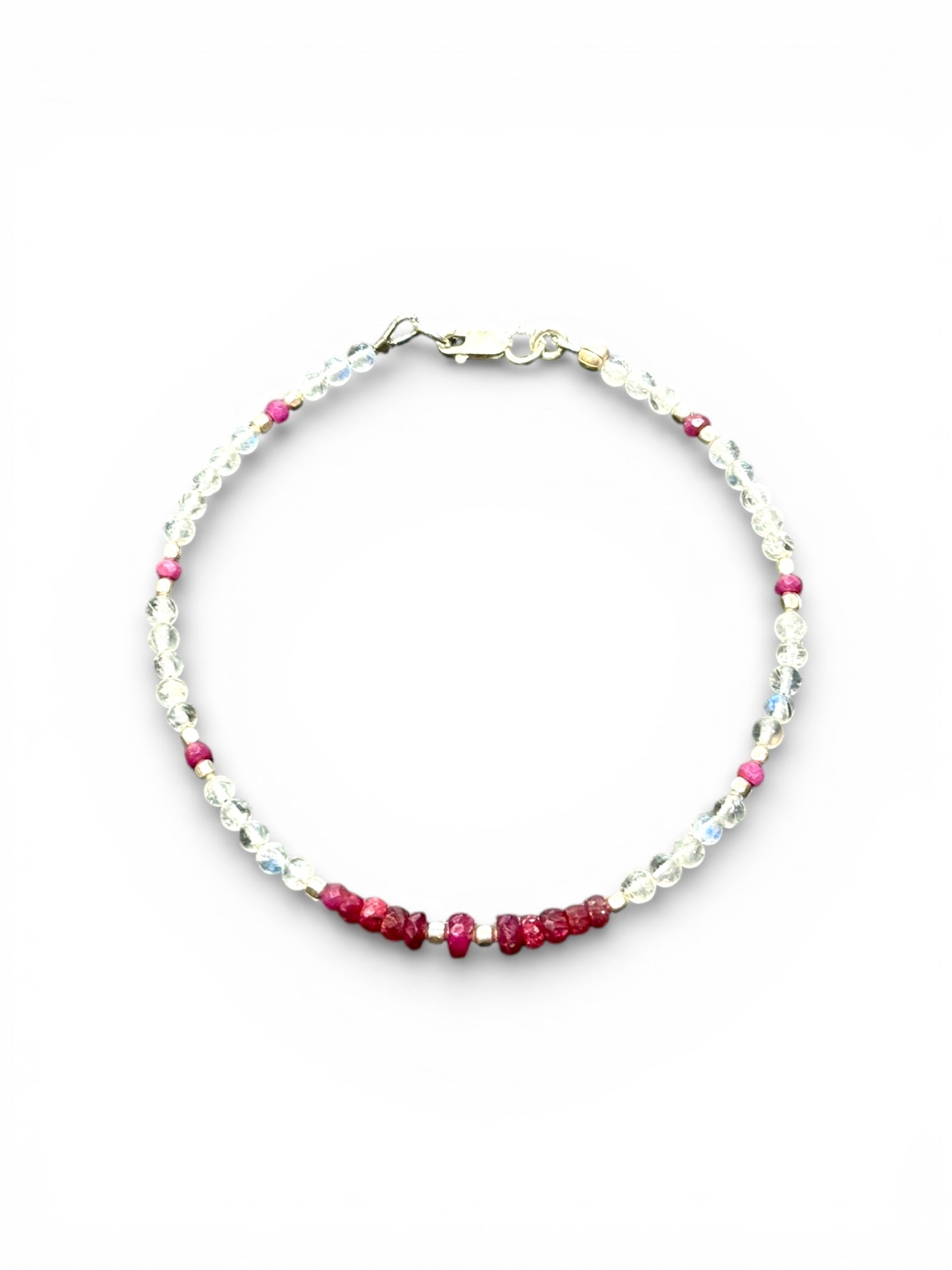 Fine beaded bracelet of facet cut ruby and round rainbow moonstone beads, finished with sterling silver beads and clasp. Length 20.6 cm, size 19 cm