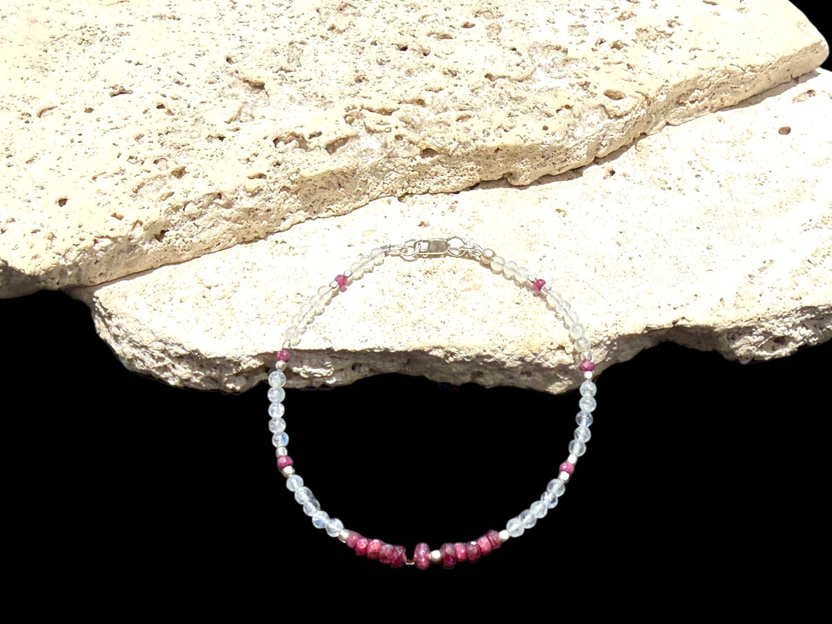 Fine beaded bracelet of facet cut ruby and round rainbow moonstone beads, finished with sterling silver beads and clasp. Length 20.6 cm, size 19 cm