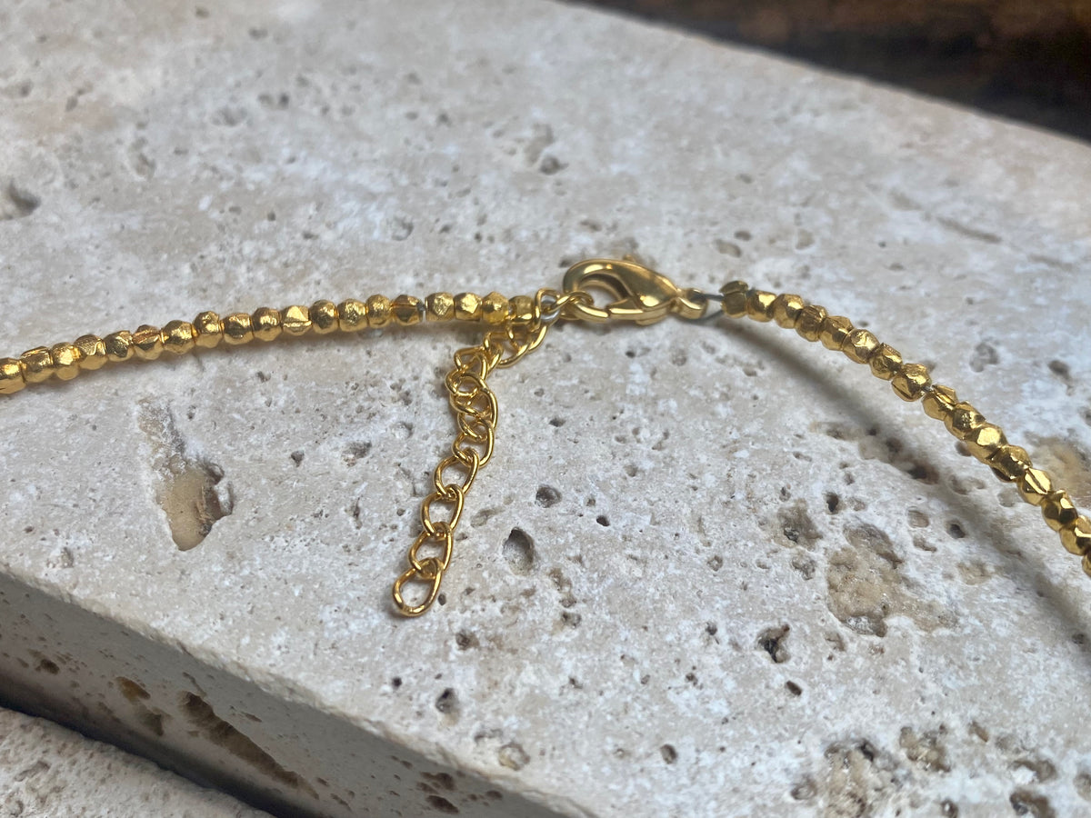 Vibrant gemstones adorn this elegant multi charm necklace. Plated 22k gold over brass, the multicoloured gemstones are evenly spaced and bezel-set to highlight the beauty of each gemstone. This necklace is designed to be worn short, but comes with an extension chain so you can set the length according to your neckline. Measurements: length 41 cm, with extension chain 45.5 cm