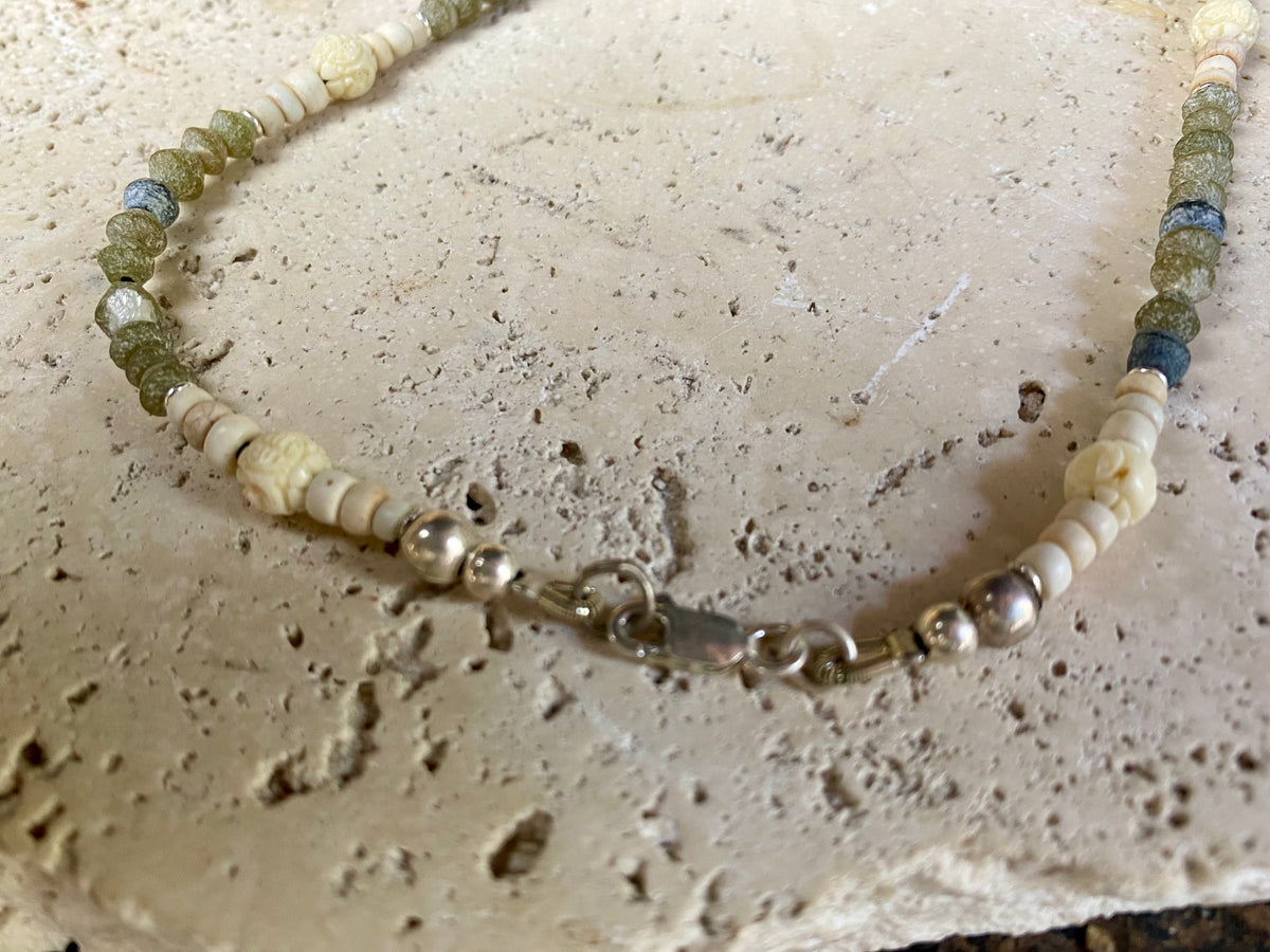 Tribally inspired stone necklace featuring prehnite, jasper, lotus root, carved white coral , glass and sterling silver.  Length 39.5 cm