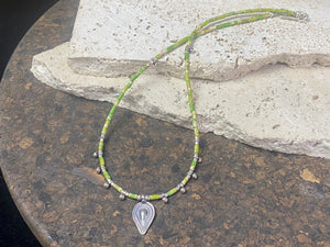 This very pretty necklace is made from tube cut imperial green jasper, highlighted with traditional handmade sterling silver Rajasthani ball beads and a tribal pendant. Finished with sterling silver findings and hook clasp. The pendant represents the shiva lingam/yoni. Length 40.5 cm
