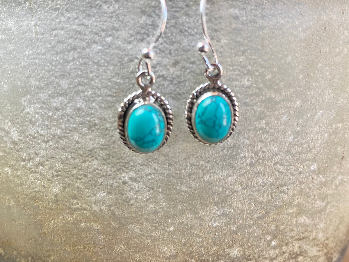 Elegant oval shaped earrings with a beautifully detailed bezel to show off the natural beauty of the cabochon stones. Sterling silver hooks complete the look. Our earrings are open-backed to allow natural light to show through. Length including hook 2.5 cm