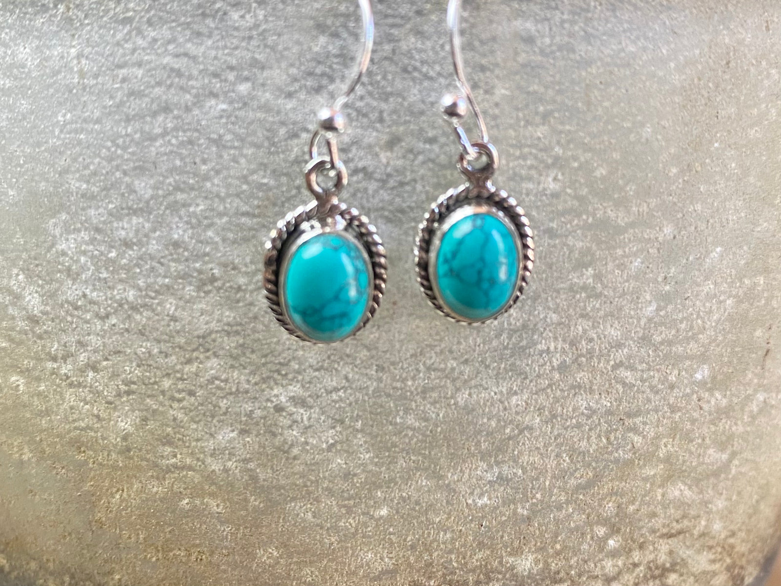 Elegant oval shaped earrings with a beautifully detailed bezel to show off the natural beauty of the cabochon stones. Sterling silver hooks complete the look. Our earrings are open-backed to allow natural light to show through. Length including hook 2.5 cm