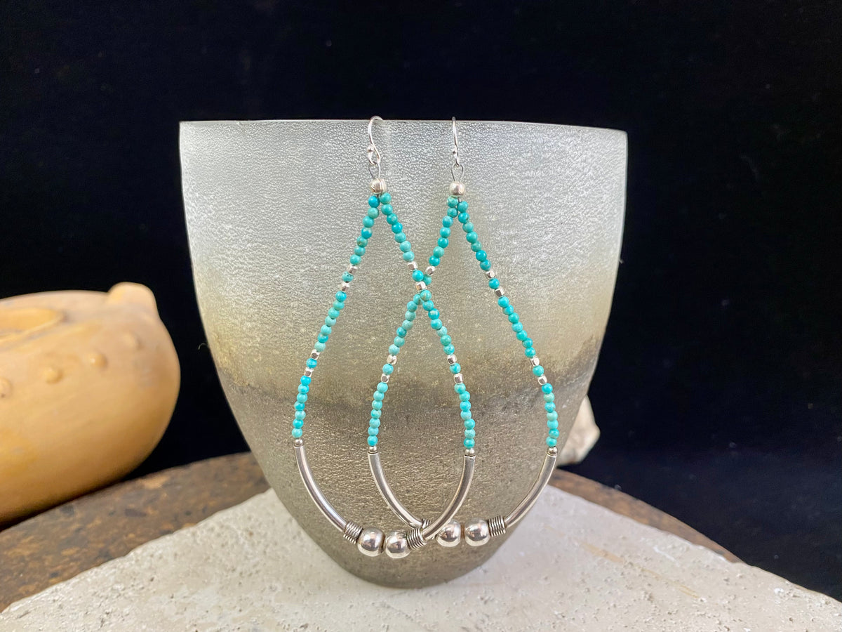 Hand crafted using tiny natural turquoise beads and 925 sterling silver. These very long earrings are unique.  Natural Arizona turquoise Sterling silver hooks and bead detailing Light and easy to wear  Measurement: total height including hook approximately 9.5 cm (3.75 in)