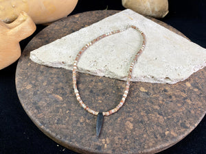 This unique necklace is made from heshi amazonite quartz druzy beads, highlighted with Kachin Burmese shell beads and a pendant made from unpolished onyx. Finished with sterling silver findings and hook clasp. Our necklace will look great on either men or women. Measurements: length including clasp 43.5 cm (17”)
