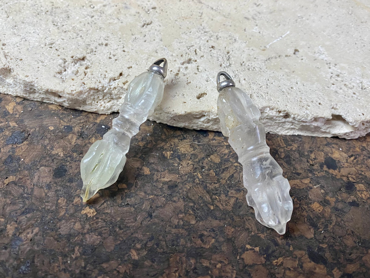 Hand carved rock crystal dorje or vajra pendants. Top mounted sterling silver bail. Approximately 6 cm in length and carved from Himalayan quartz.  