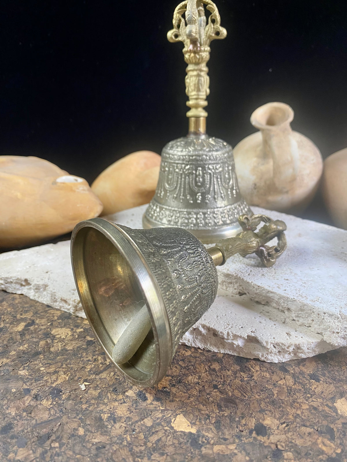 Tibetan Buddhist bells in two sizes. They feature fine detailing, are encircled with the mantra Om Mani Padmi Hum and are topped with the image of the Buddha and the dorje. These very high quality bells have a beautiful tone, the larger is deeper and richer, the smaller is higher and sweeter. Please watch our two videos to hear their sound.  Measurements:  Large: height 16 cm, diameter 9 cm Small: height 13 cm, diameter 7.5