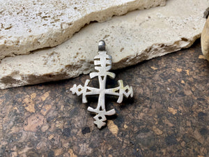 Mid 20th century Ethiopian silver crucifix. This may have been cut from a Marie Therese silver thaler, as the antique ones always are, however I believe that the style is more recent. Tests as silver. Plain on front side, plain back. Some wear at the head of the bail commensurate with its age. A wearable and collectable piece of jewellery.  Measurements: length including bail 6 cm