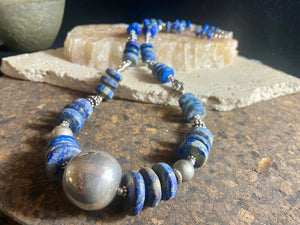 Tribal lapis lazuli and silver necklace, crafted from antique unpolished graduated Afghani lapis lazuli and handmade, vintage and antique tribal silver beads. This stunning, long necklace is finished with a sterling silver clasp and weighs 170 g. Measurements: 68 cm in length