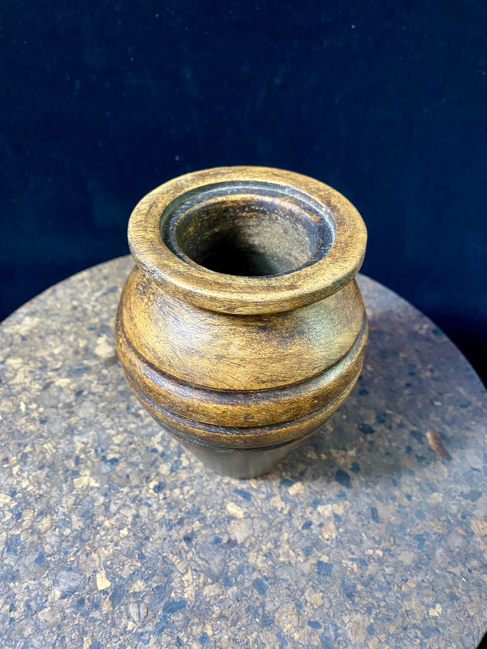 A small shaped wood pot with three carved lines of decoration. Carved from hardwood, most likely rosewood. Late 20th century vintage. Measurements: diameter at widest point 9 cm, diameter of opening 4.5 cm, height 12 cm