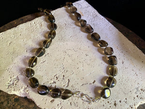 This simple necklace is crafted from high quality, tumbled and naturally dark smokey quartz stone and highlighted with sterling silver spacer beads. Finished with sterling silver ends. Measurements: Total length including clasp 50.5 cm