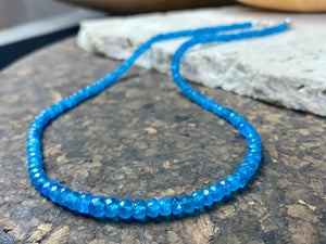 Short dark blue apatite necklace featuring graduated faceted apatite beads finished with a sterling silver lobster clasp. This is a lovely statement necklace that matches any skin tone or clothing. These stone are natural and not heat treated Measurements: 39.7 cm total length 