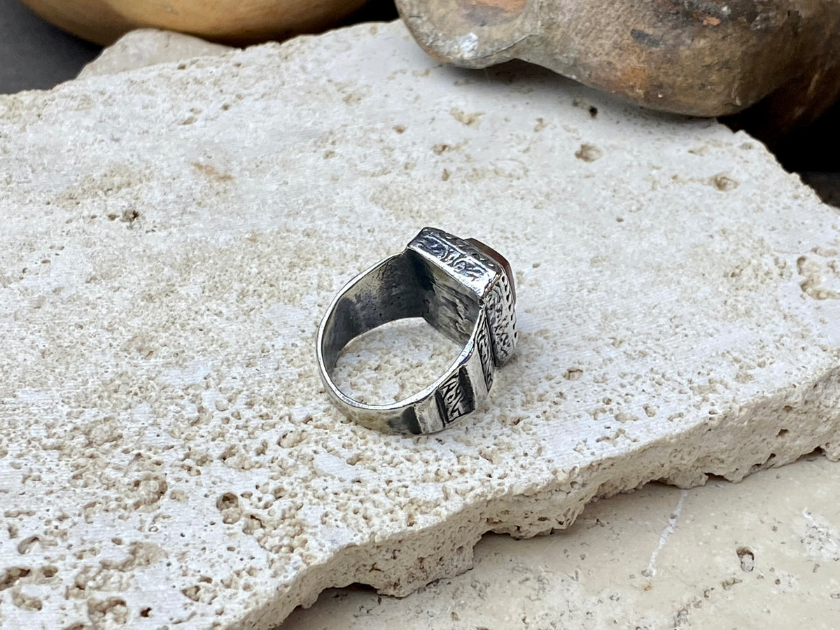 An elegant ring featuring a beautiful dark carnelian stone. The stone shows some wear commensurate with its age. Afghanistan, early to mid 20th century. Can be worn by either men or women. Measurements: Ring face 1.6 x 1.3 cm, inner diameter 18.5 mm | Size 8.5 | No 19