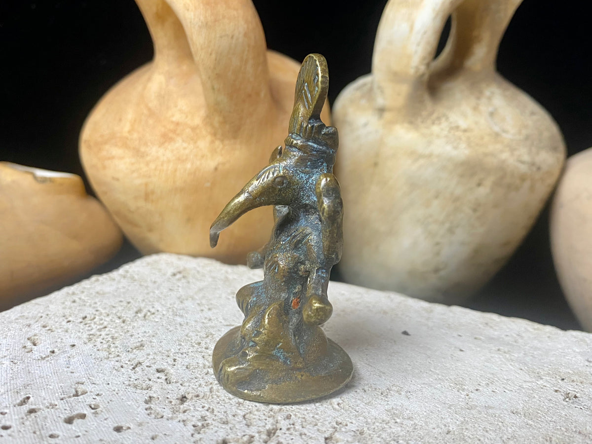 This exquisite miniature Ganesh statue features fine, elegant features, a face rubbed through many years of worship and a high tribal headdress typical of the eastern states of India. Early 20th century, India, bronze alloy.  Measurements: height 6.5 cm, width 3.2 cm, depth 2.5 cm