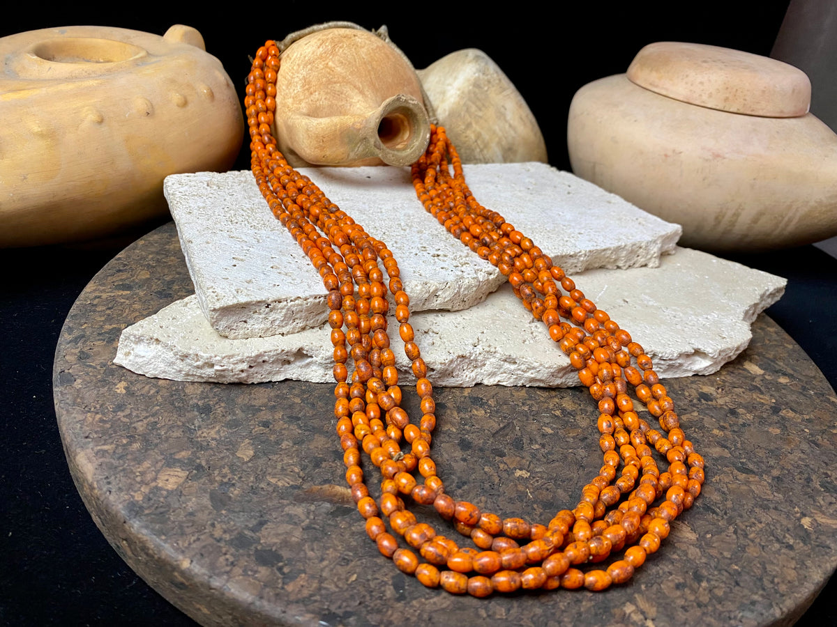 Vintage Naga long multistrand necklace made up of old ceramic beads with wrapped cotton ends and a coin button as fastener.  Measurements: 74 cm length