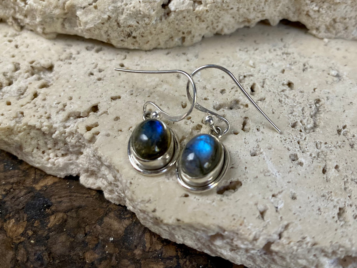 Simply elegant oval earrings with a small shadow box bezel to show off the beauty of the natural cabochon gemstones. Sterling silver hooks complete the look. Our earrings are open-backed to allow the light of the stones to show through. Length including hook 2.5 cm