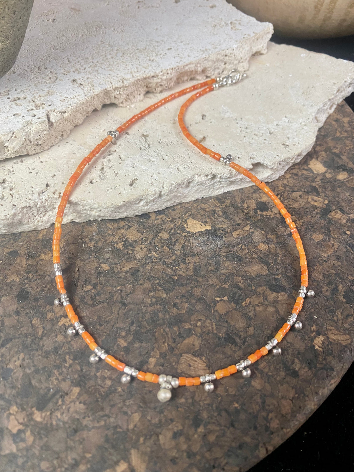 Fine cut beads of bamboo coral, highlighted with traditional handmade sterling silver Rajasthani ball beads. Finished with sterling silver findings and hook clasp. Designed to be unisex, this necklace would look stunning on men and women. Measurements: 41 cm (15.85")