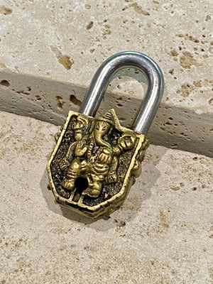 Small brass Indian deity padlocks embossed with the image of Ganesh or Laxmi. to keep your possessions safe and blessed. On the back is the Om, powerful Buddhist protective symbol. Two keys provided with every lock. On the top of each is the viswa vajra, a Buddhist protective symbol. Measurements: height 6.5 cm, width 3 cm, depth 1.5 cm