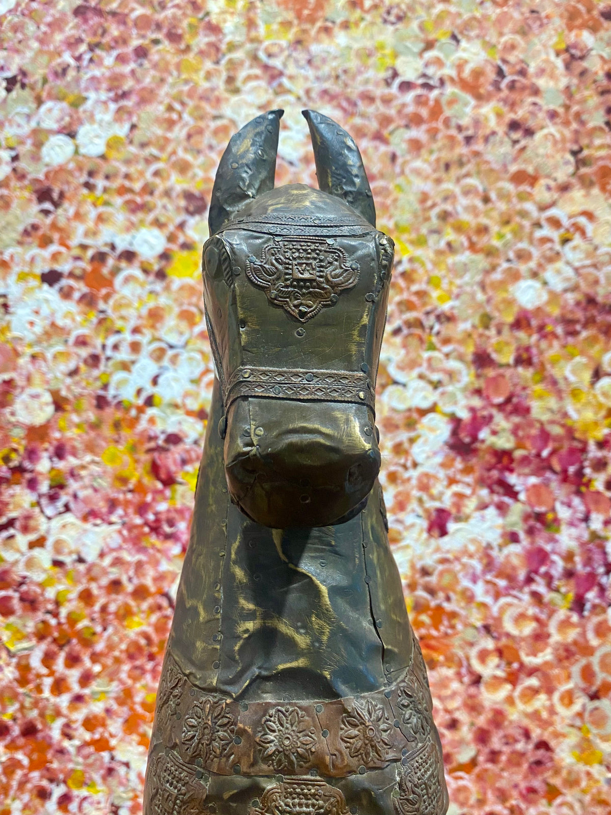 Antique Indian rocking horse. Covered entirely in sheets of embossed brass and copper sheet with floral and ornamental plaques, strap work and highly embossed decoration. Hardwood Early 20th century, southern India. Measurements: height to ear 52 cm, length 40.5 cm, width 13.5 cm.