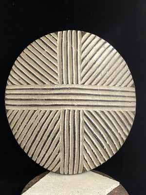 Round shield, Kuba people, vintage 1930's.  This shield features a patination of intersecting geometric lines and white pigment patina.  Measurements: diameter 42 cm, height approximately 6 cm