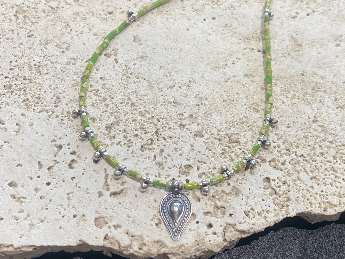 This very pretty necklace is made from tube cut imperial green jasper, highlighted with traditional handmade sterling silver Rajasthani ball beads and a tribal pendant. Finished with sterling silver findings and hook clasp. The pendant represents the shiva lingam/yoni. Length 40.5 cm