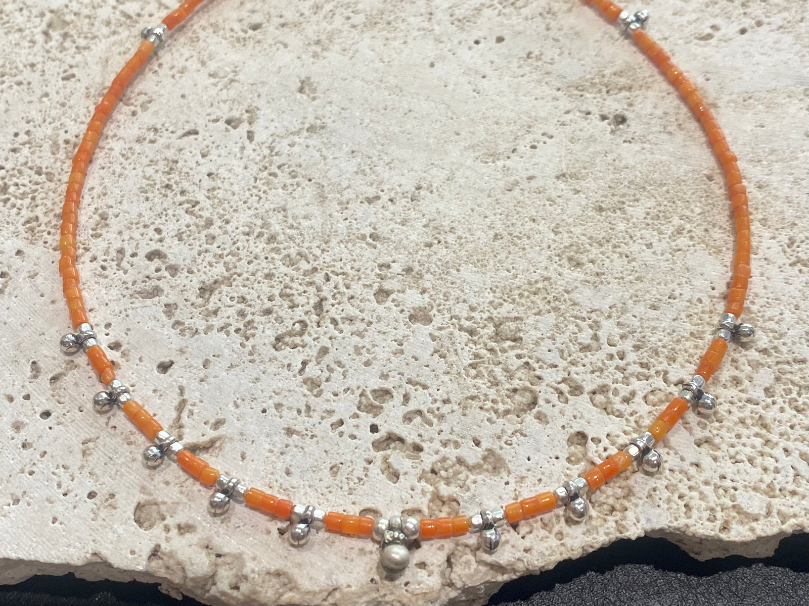 Fine cut beads of bamboo coral, highlighted with traditional handmade sterling silver Rajasthani ball beads. Finished with sterling silver findings and hook clasp. Designed to be unisex, this necklace would look stunning on men and women. Measurements: 41 cm (15.85")