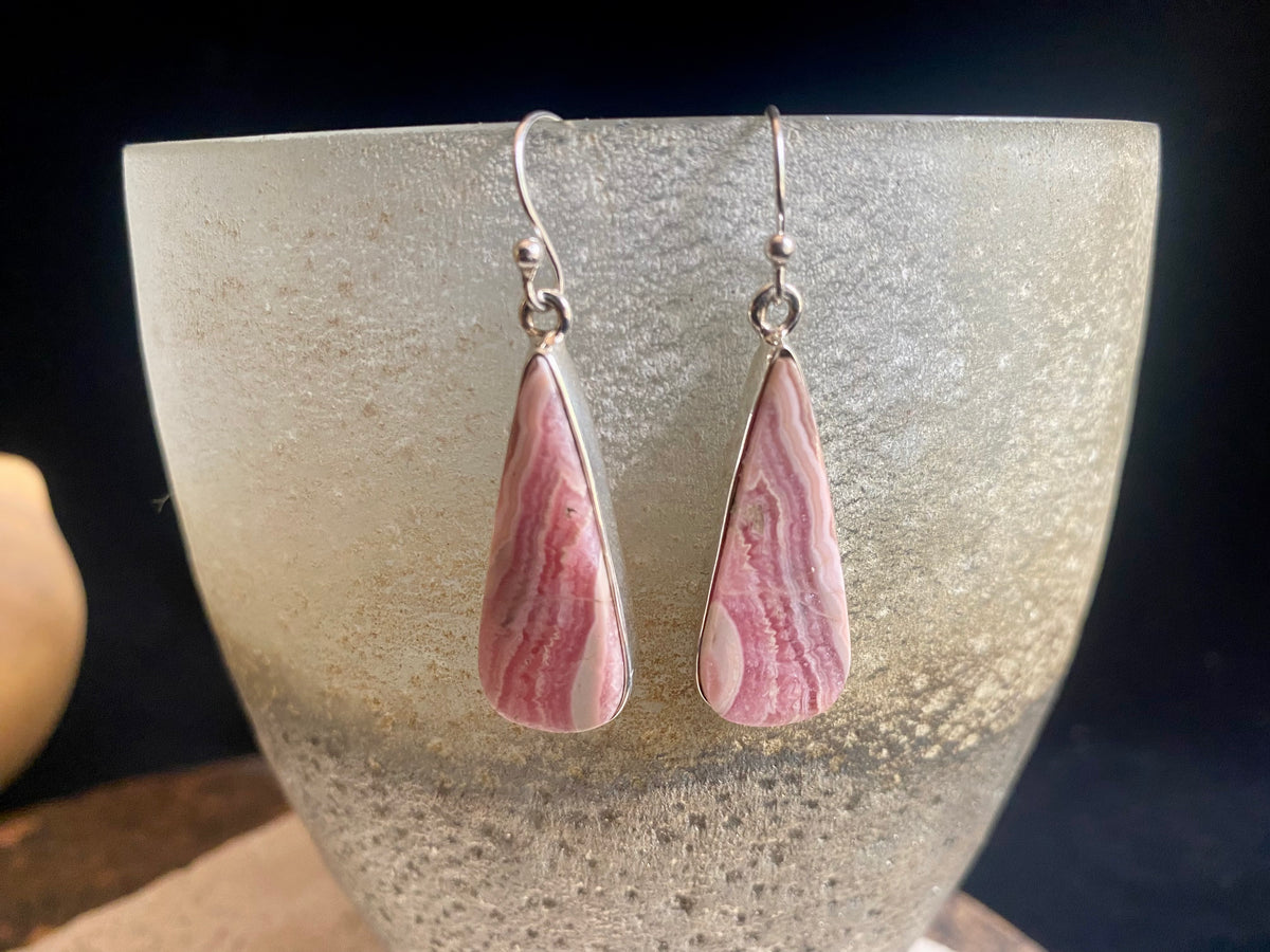 The most beautiful rhodochrosite we've ever seen. Every piece tells a story, and all earring pairs feature perfectly matched stones set in sterling silver bezels. Finished with sterling silver hooks.