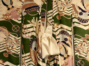 Small, hand sewn child's kimono suitable for either sex. A tasteful design features greens, tans, navy, lilac and pale blue colours in an abstracted design reminiscent of its era. Padded and lined. Hand stitched silk ties with fine thread tassel detailing. No damage, excellent condition. Circa 1950's.