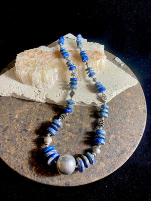 Tribal lapis lazuli and silver necklace, crafted from antique unpolished graduated Afghani lapis lazuli and handmade, vintage and antique tribal silver beads. This stunning, long necklace is finished with a sterling silver clasp and weighs 170 g. Measurements: 68 cm in length