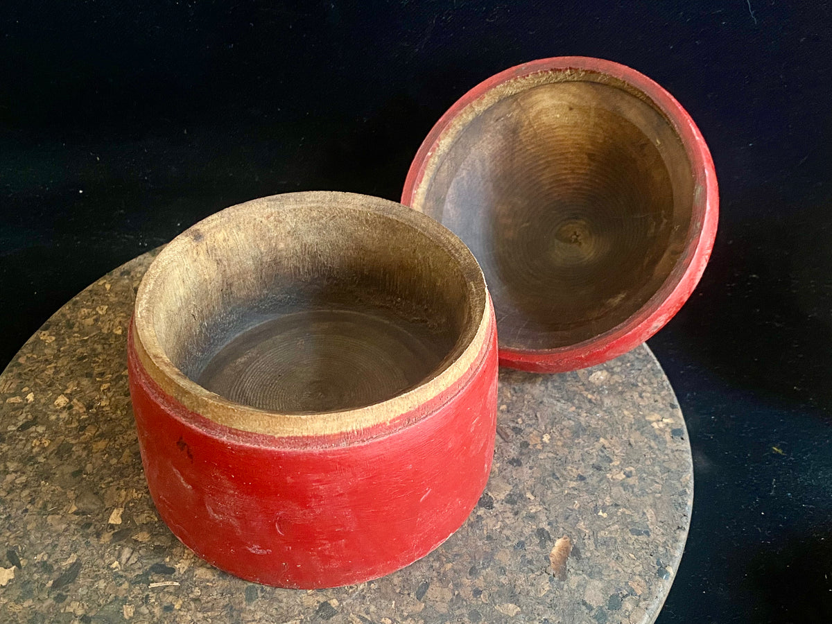 Large red lacquered tikka pot or tikka boxes. Hand carved from single hollowed out pieces of teak, these lidded pots traditionally hold the red vermillion (bindi) powder used for marking the forehead during Hindu ceremonies. They date to the early 1900s. Measurements: approximate diameter 12-14 cm, height 16-18 cm 