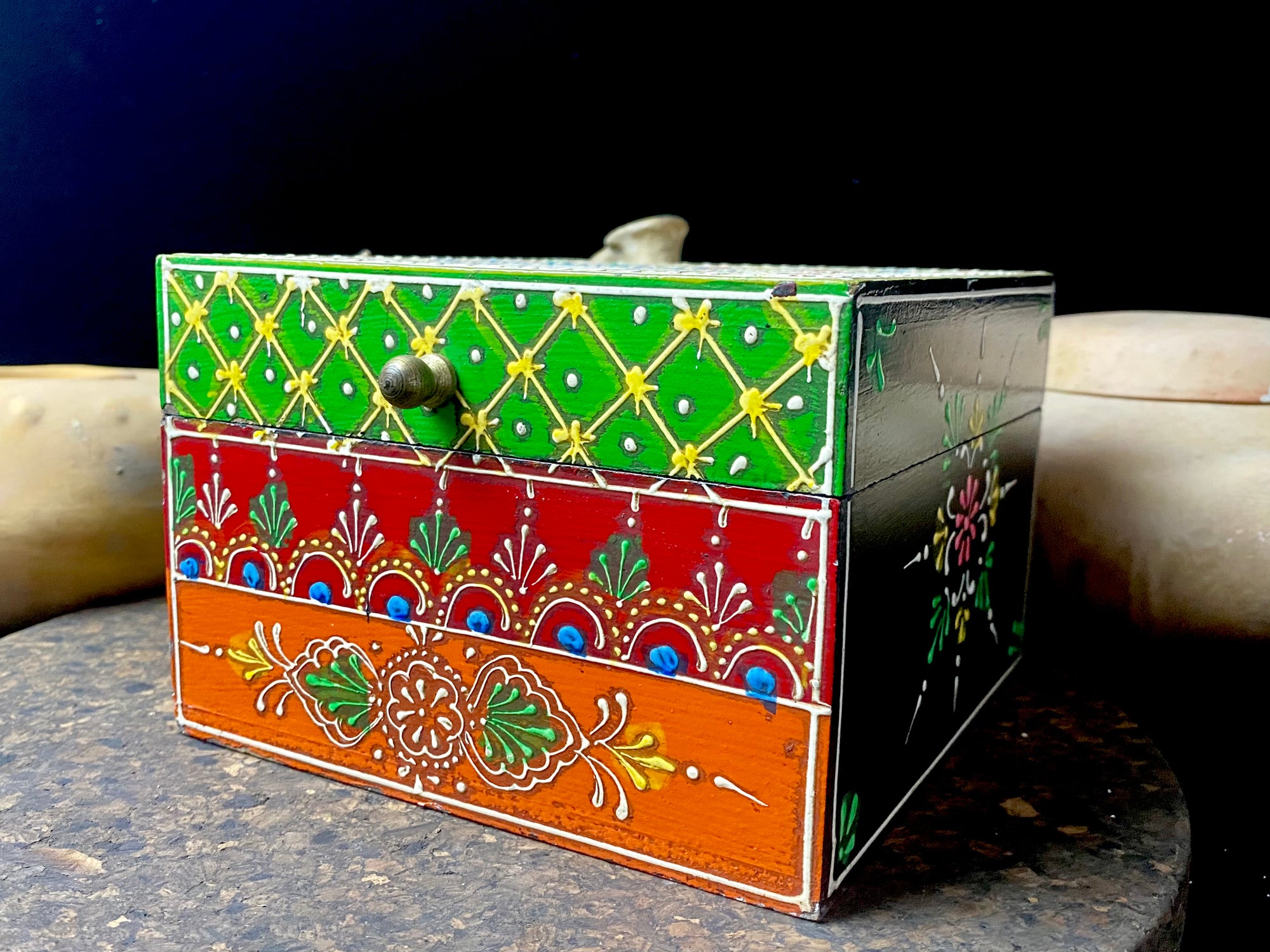 Vibrant hand painted trinket box. Small brass knob as handle. Perfect little boxes to keep your trinkets in. Great box to hold your essential oils or jewellery. From Rajasthan, India. Measurements: 15 x 15 cm, height 10.5 cm