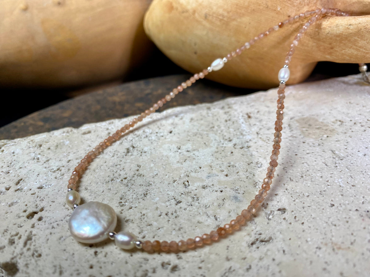 Natural clear pink/orange sunstone bead necklace is teamed with cultured pearls and sterling silver detailing. A silver lobster clasp complete the look. Length 40.5 cm