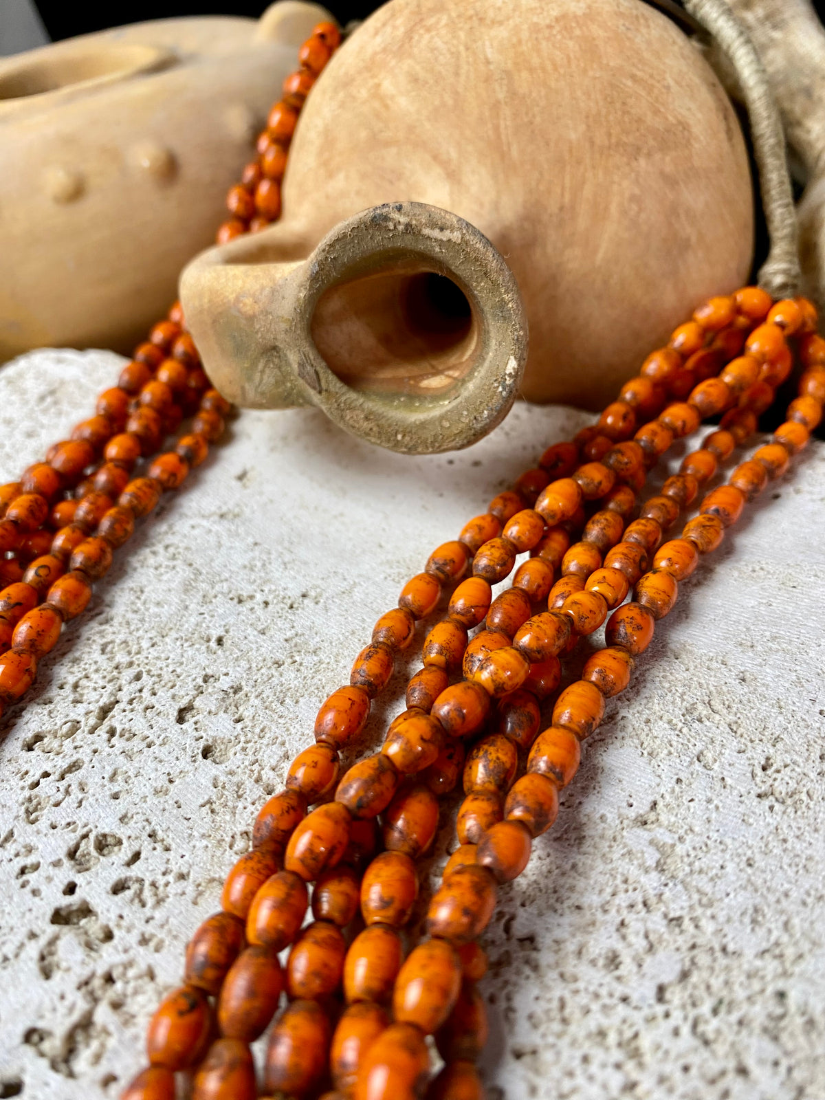 Vintage Naga long multistrand necklace made up of old ceramic beads with wrapped cotton ends and a coin button as fastener.  Measurements: 74 cm length