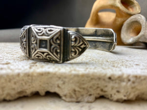 A modern interpretation of an antique style of bracelet, this fine cuff is hand crafted from sterling silver by Rajasthani silversmiths. Exquisitely detailed, the oxidised finish shows off the workmanship beautifully. There is some small room for movement in this cuff, and it is designed to fit an average sized wrist.  Measurements: Inside opening is 6.5 cm, with room for expansion or contraction