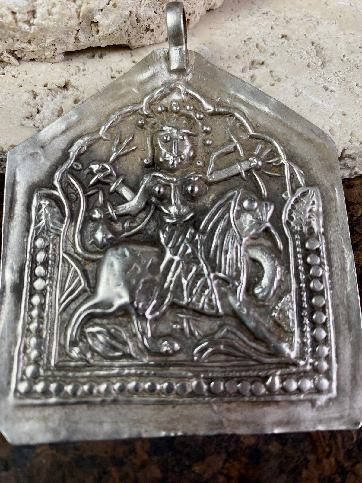 Very large Durga amulet - wear as a pendant or hang as an ornament. Early 20th century, the bail has been replaced at some stage as it most likely wore through..  Measurements: height 8.5 cm including bail, width 6.5 cm