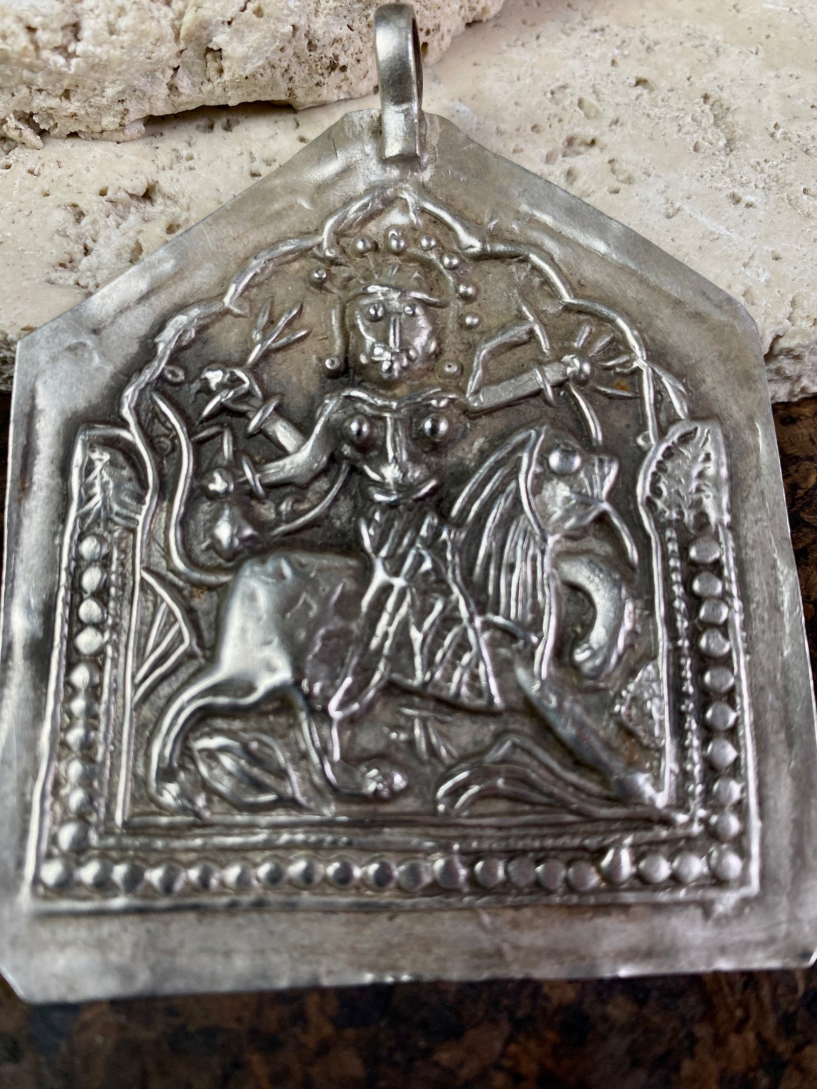 Very large Durga amulet - wear as a pendant or hang as an ornament. Early 20th century, the bail has been replaced at some stage as it most likely wore through..  Measurements: height 8.5 cm including bail, width 6.5 cm