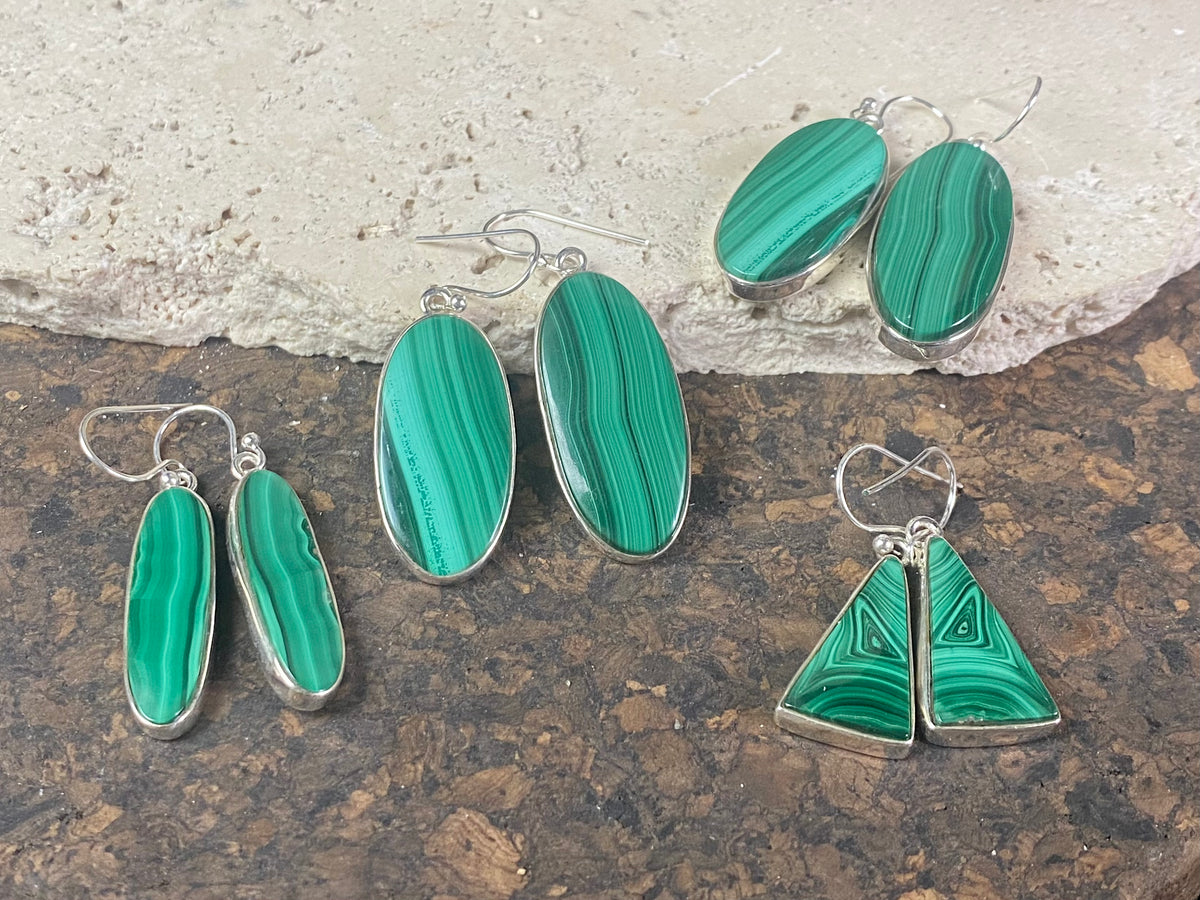 Our elegant earrings feature perfectly matched malachite cabochons set in sterling silver bezels. Finished with sterling silver hooks.
