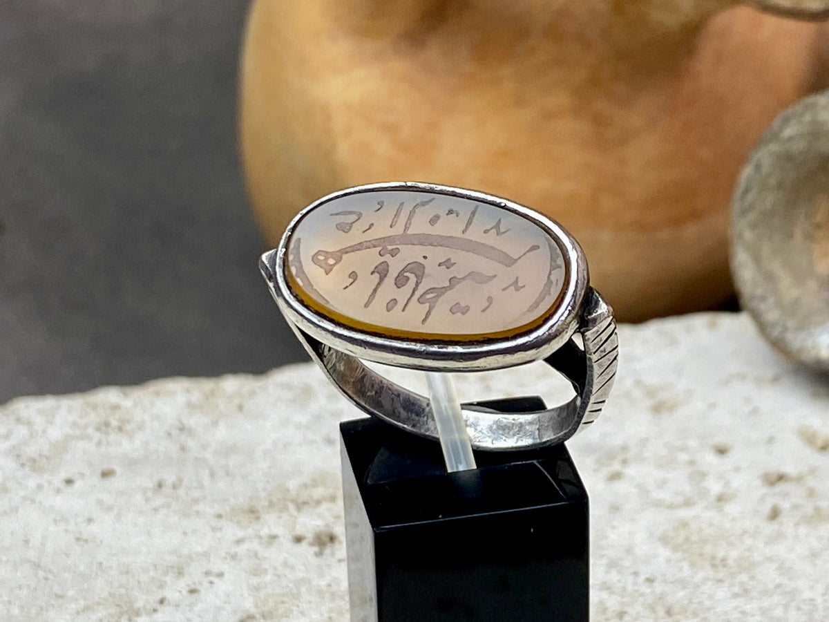 Afghani ring features an antique honey-coloured engraved carnelian prayer plaque set into a new silver band. Sits high on the finger and is a statement piece. High grade or sterling silver has been used to make the ring band. Men or women's ring. Measurements: Carnelian 2.4 x 1.4 cm, inner diameter 19.75 mm | Size 10