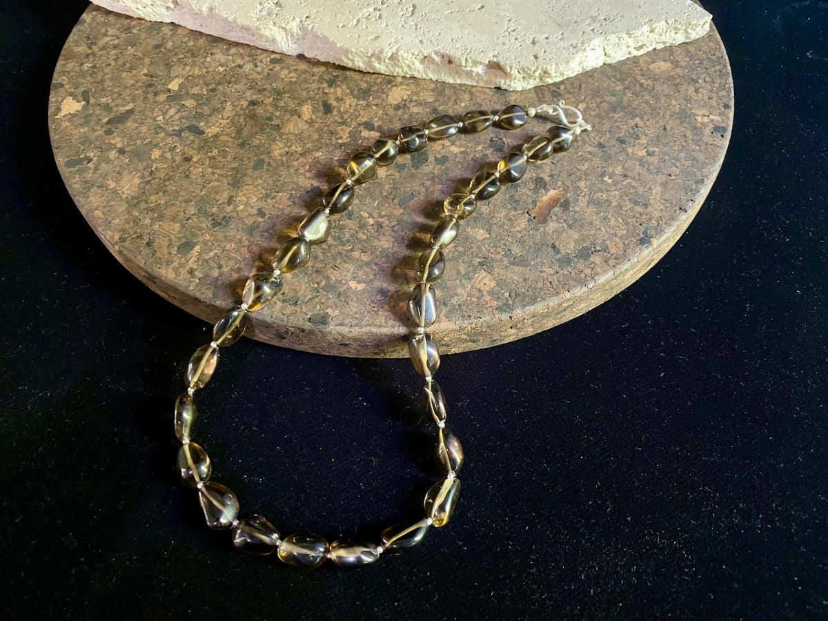 This simple necklace is crafted from high quality, tumbled and naturally dark smokey quartz stone and highlighted with sterling silver spacer beads. Finished with sterling silver ends. Measurements: Total length including clasp 50.5 cm