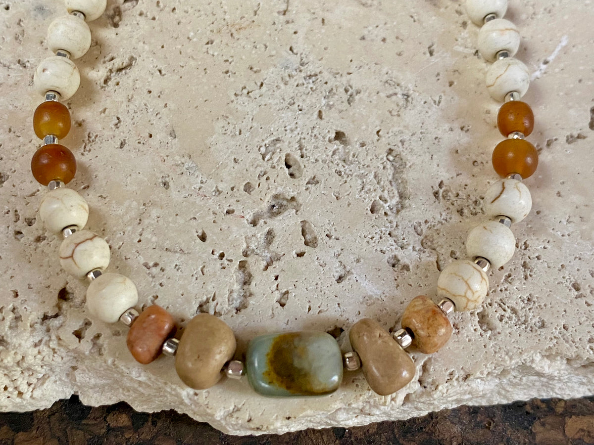 Our unique statement necklace features beautiful vintage beads from the Kashgar collection - turquoise centre bead, jasper beads from the Philippines, howlite beads, buffalo horn beads and  925 sterling silver detailing and lobster clasp. Length 45 cm.